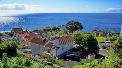 an aerial view of a house and the ocean at Casa Do Avô Faidoca # PICO HOLIDAY RENTALS in Calheta de Nesquim