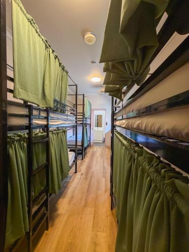 a row of bunk beds in a room at Global Backpackers Youth Hostel in Port Douglas