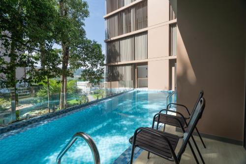 a balcony with a swimming pool in a building at Wyndham Garden Phuket Kamala in Kamala Beach
