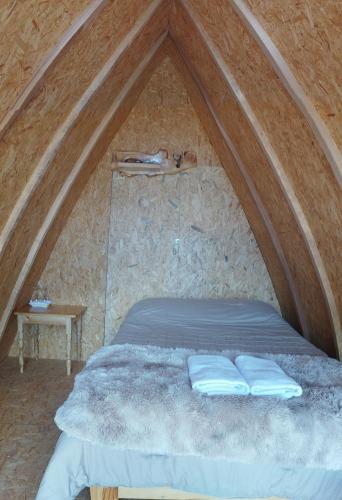 a bed with two pillows on it in a tent at Casa rural mirador wilcacocha in Huaraz