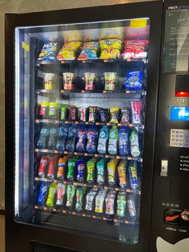 a vending machine filled with lots of drinks and soda at Ritsurin Boutique Hotel - โรงแรมริทสุริน บูติค in Phuket