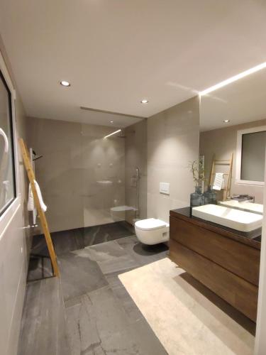 a bathroom with a sink and a toilet and a mirror at Terrace Ferragudo River View Flat Super in Ferragudo