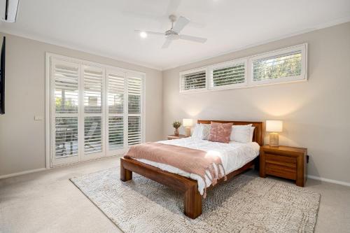 a bedroom with a bed and two windows at Ivory Sands, Sorrento in Sorrento