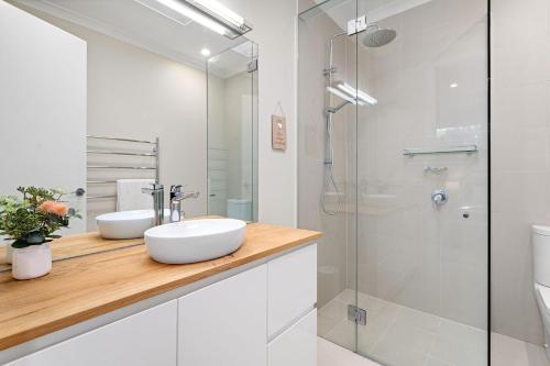 a white bathroom with a sink and a shower at Ivory Sands, Sorrento in Sorrento