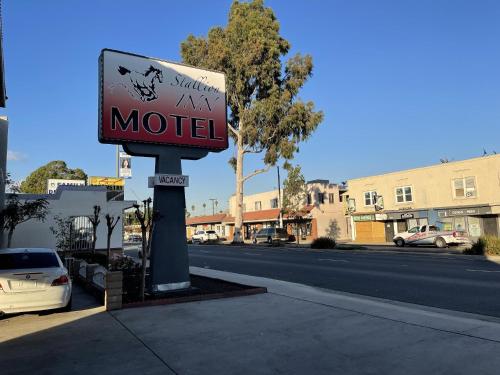 a motel sign on the side of a street at Stallion Inn Motel in Long Beach