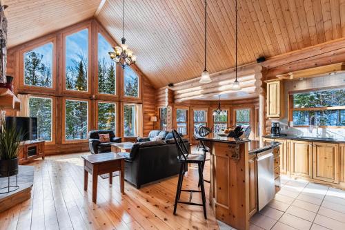a living room with a couch and a table at Fiddler Lake Resort - Deer 61 in Mille-Isles