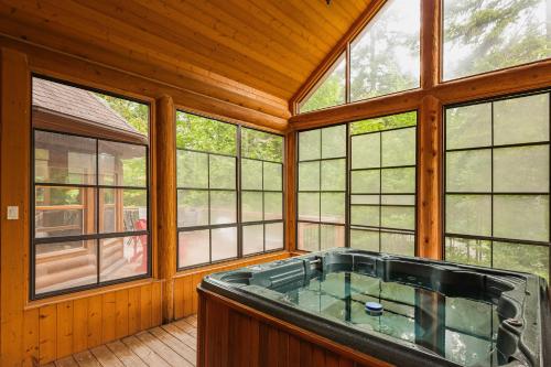a large room with a hot tub in a house at Fiddler Lake Resort - Deer 61 in Mille-Isles