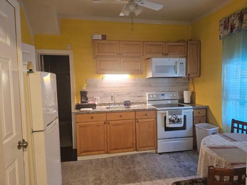 a kitchen with wooden cabinets and a white stove top oven at 2#studio In Clearwater usa in Clearwater