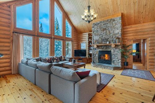 a living room with a couch and a fireplace at Fiddler Lake Resort - Deer 68 in Mille-Isles