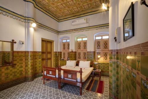 a bathroom with a tub and a shower at Chettinadu Mansion – An Authentic Heritage Palace in Kānādukāttān