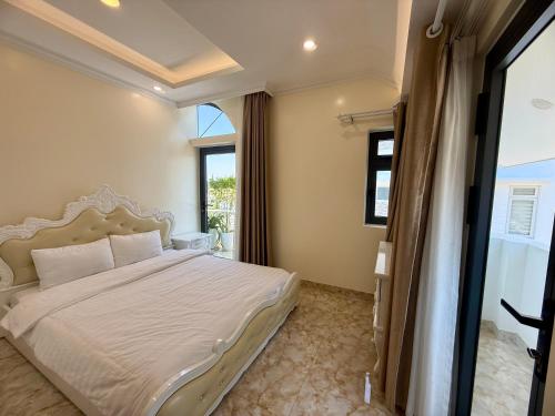 a bedroom with a large bed and a window at Bibo House - Near Xuan Huong Lake & Center in Da Lat