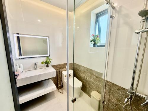 a bathroom with a toilet and a sink and a shower at Bibo House - Near Xuan Huong Lake & Center in Da Lat