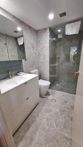 a bathroom with a toilet and a sink and a shower at The Ritz Resort Heated Pool in Gold Coast