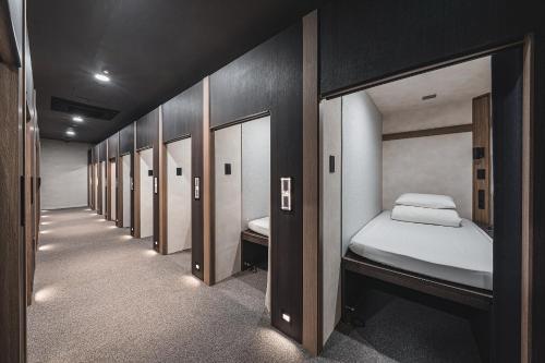 a row of bunk beds in a row at GOYOO INN & cabins in Seoul