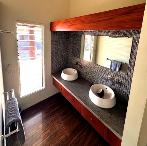 a bathroom with two sinks and a mirror at Luxury Ocean View Villa, Savusavu Bay, Blue Bayou Bure with Starlink in Savusavu