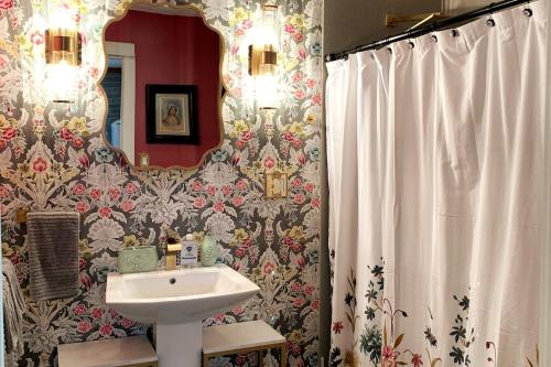 a bathroom with a sink and a mirror at Poppy's Place in Chanute