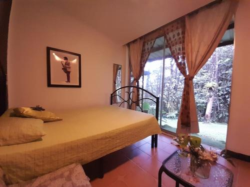 a bedroom with a bed and a window at El Nido Cerro Azul in Cerro Azul