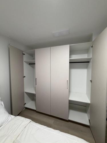 a bedroom with white closets and a bed at Granite Grove Suite in Winnipeg