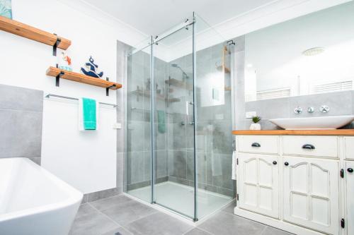 a bathroom with a shower and a sink at Canny Breeze in Agnes Water
