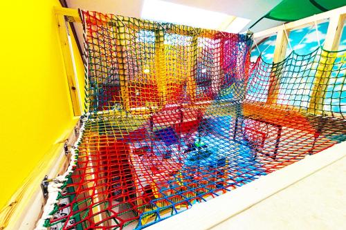 a colorful cage with chairs in a room at Skytree 12pax Family-Friendly with Indoor Playground in Tokyo