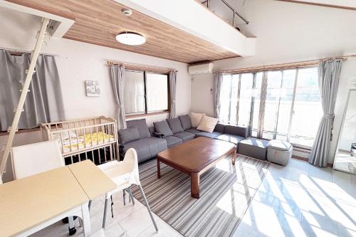 a living room with a couch and a table at Skytree 12pax Family-Friendly with Indoor Playground in Tokyo