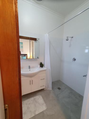 a bathroom with a sink and a mirror at Sunbury Central in Sunbury