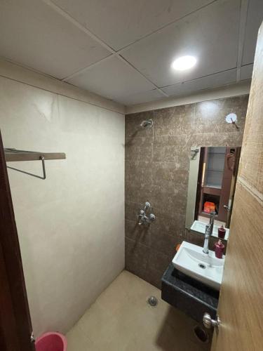 a bathroom with a sink and a mirror at isuites in Ghaziabad