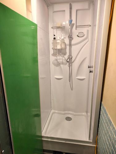 a shower with a glass door in a bathroom at オホーツクハウスえんがる in Engaru