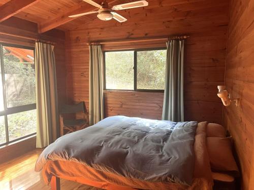 a bedroom with a bed and a ceiling fan at For Rest at Crescent Head in Crescent Head