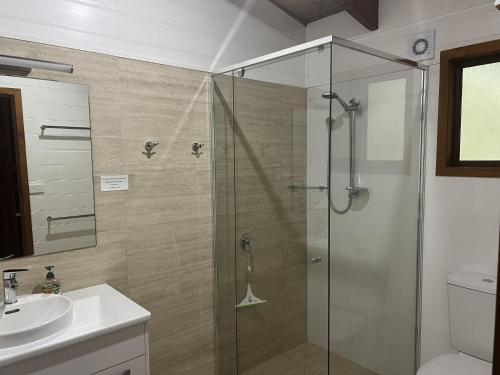 a bathroom with a shower and a sink at For Rest at Crescent Head in Crescent Head