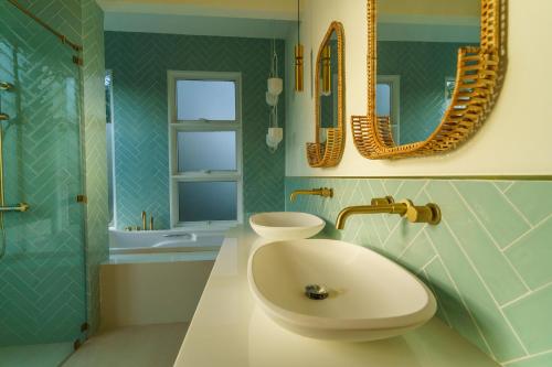 a bathroom with a sink and a mirror at Santi Villa Wat Seree in Ko Phangan