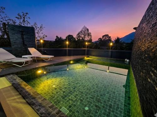 a swimming pool with lights on top of a house at Kathu V pool villa 170 in Kathu