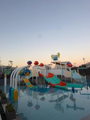 a pool with a water park with slides at Vibe and Stay - Staycation home near Tagaytay in Calo
