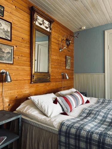 a bedroom with a bed and a mirror on the wall at Mellby 11 Bed & Breakfast in Kivik