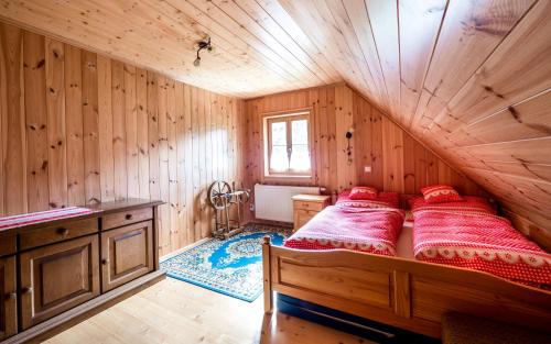 a bedroom with a bed in a wooden room at Chalupa Pod Lomem in Dolní Morava