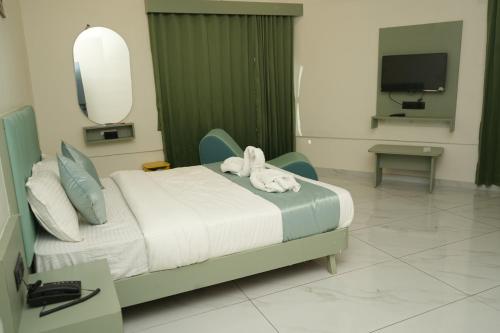 a hospital room with a bed with a stuffed animal on it at Hotel Bandhan in Himatnagar