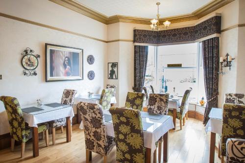 a dining room with a table and chairs at The Leicester in Southport