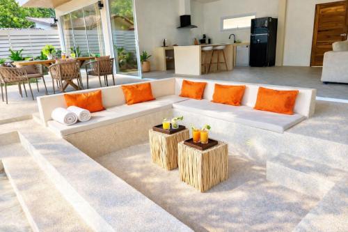 a living room with a white couch and two wooden tables at Modern Private Pool Villa - 3BR - Koh Phangan in Ko Phangan