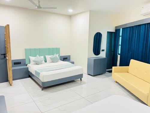 a bedroom with a bed and a couch at Hotel Bandhan in Himatnagar