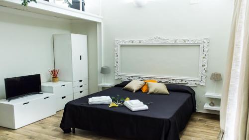 En eller flere senge i et værelse på Mimì