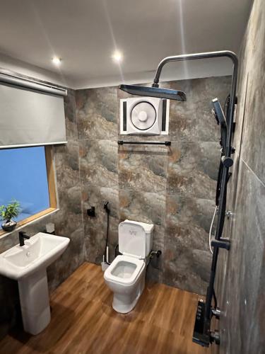 a bathroom with a toilet and a sink at Galactic Glow Villa & Resort in Deniyaya