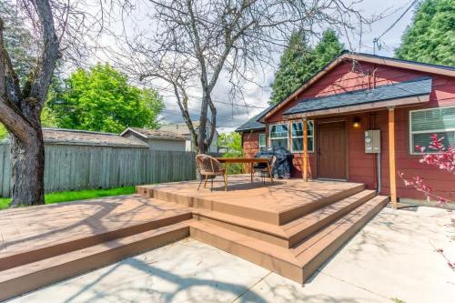 a deck with a table and a chair on a house at The Hangout House With Bonus Game Room & Foosball in Coeur d'Alene