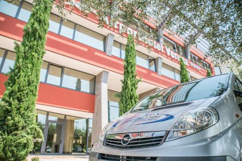 a car parked in front of a building at Airporthotel Verona Congress & Relax in Dossobuono