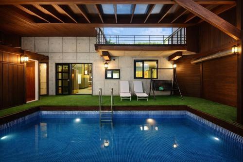 a swimming pool in the middle of a house at Gapyeong Vistahill Pension in Gapyeong