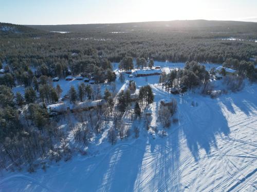 an aerial view of a forest in the snow at Kaamasen Kievari in Kaamanen