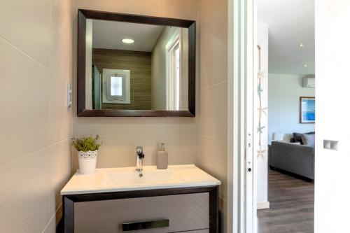 a bathroom with a sink and a mirror at CBA COSTA BRAVA - Cala Morisca in Tossa de Mar