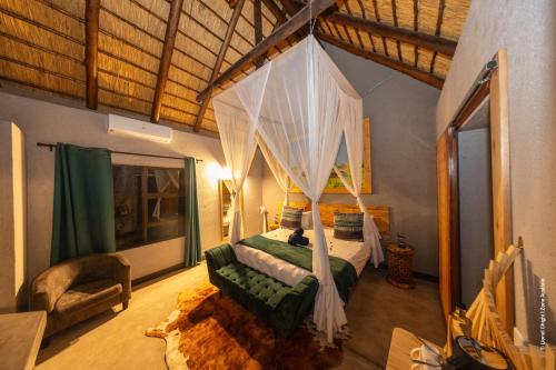 a bedroom with a canopy bed in a room at Lindiwe Safari Lodge in Hoedspruit