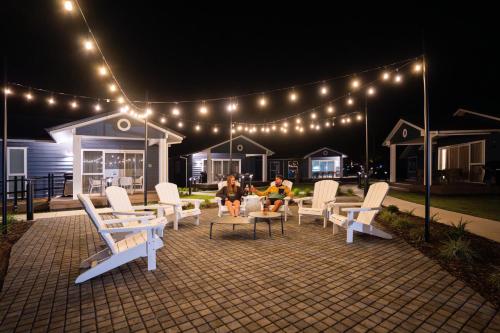 two people sitting on a patio at night with lights at Tasman Holiday Parks - Miranda in Miranda