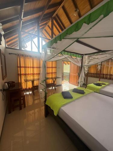 a bedroom with two bunk beds in a room at Rainforest mountain resort in Deniyaya
