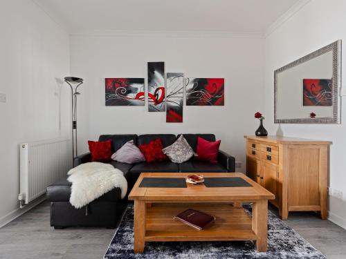 a living room with a couch and a coffee table at Ards House Self catering apartment with sea views in Oban